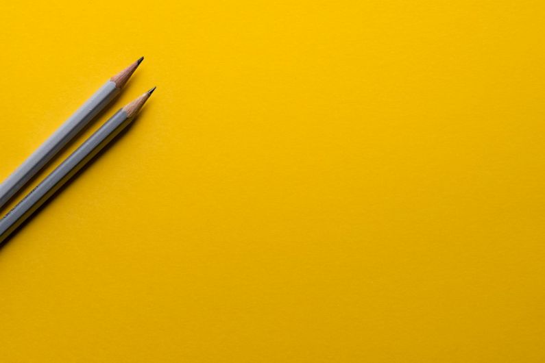 Education Automation - two gray pencils on yellow surface