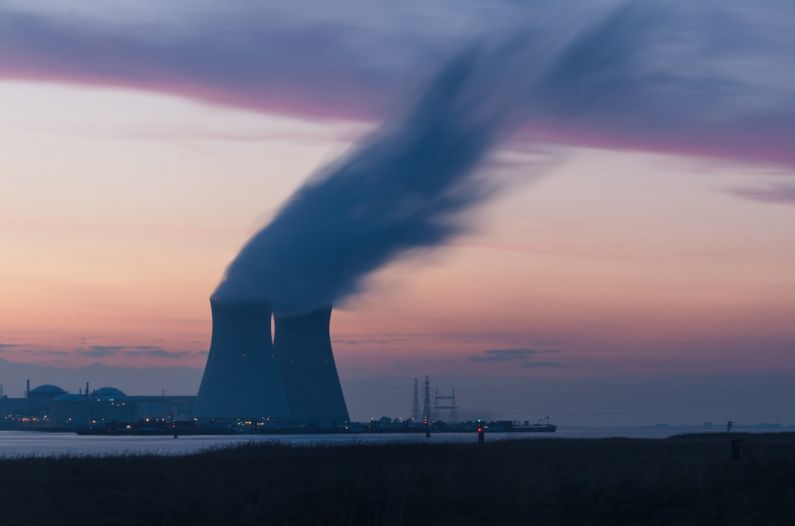 Tidal Energy - skyline photography of nuclear plant cooling tower blowing smokes under white and orange sky at daytime