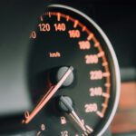 Empathetic Car - closeup photo of black analog speedometer