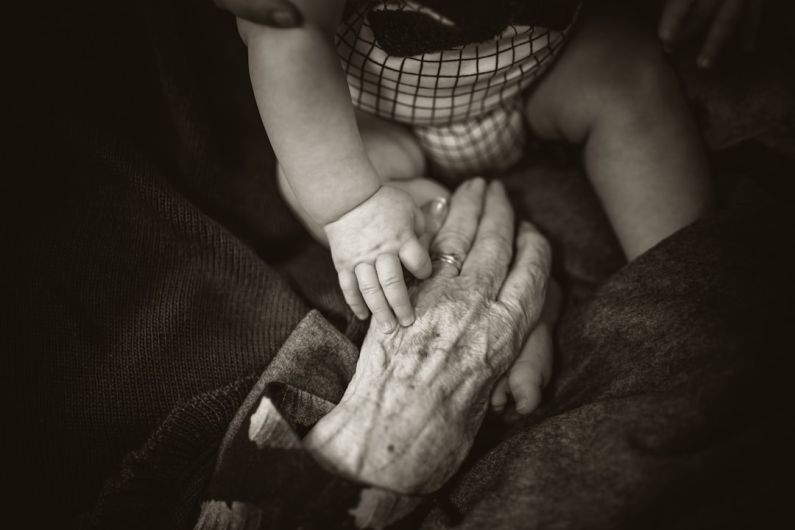 Procedural Generation - an older woman holding a baby's hand