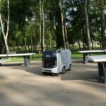 AI Traffic - an electric vehicle parked in a park next to picnic tables