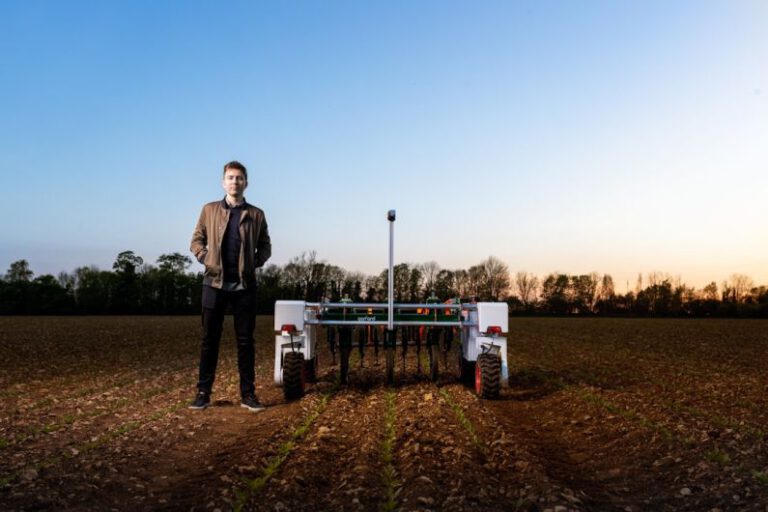 Agriculture Robot - man in black jacket standing on green grass field during daytime