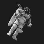 Space Race - astronaut in white suit in grayscale photography