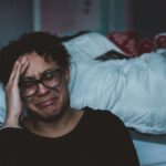Emotion AI - person crying beside bed
