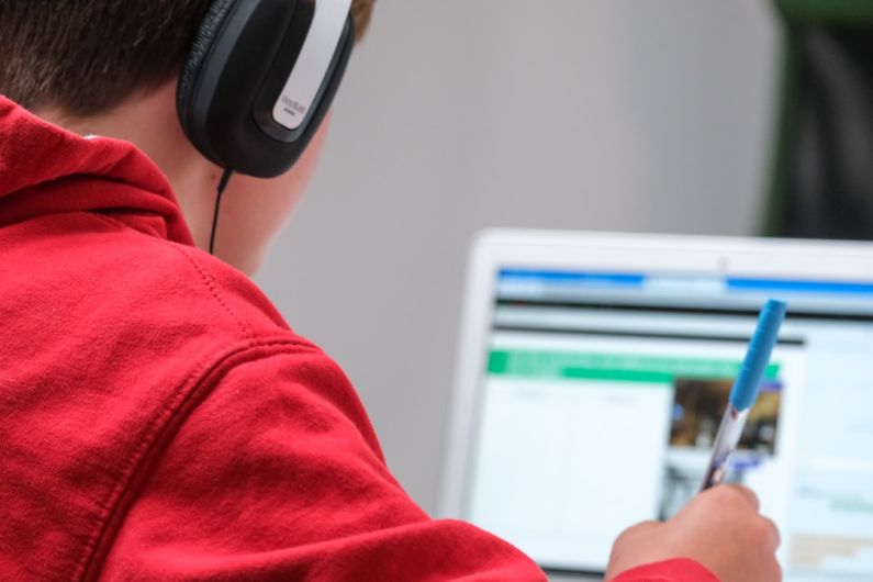 Digital Education - person in red shirt wearing black and gray headphones